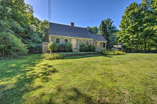 a house with a large yard in front of it at Charming Saco Home with Deck, 5 Mi to Beach! in Saco