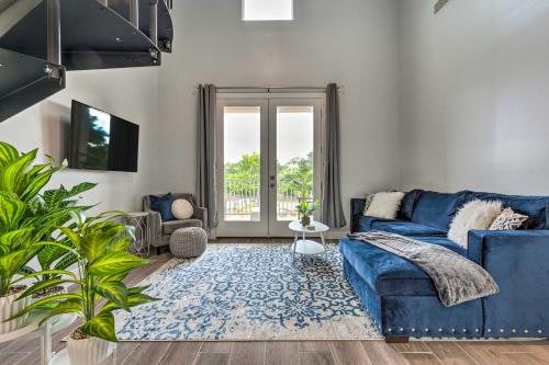 a living room with a blue couch and a blue rug at Modern Long Beach Escape about 1 Mi to Shores! in Long Beach