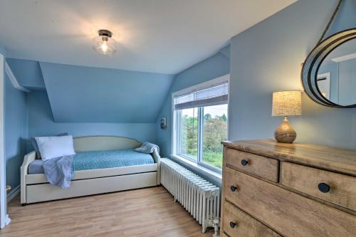 a blue room with a bed and a window at Enchanting Family House with Balcony Less Than 3 Mi to WVU! in Morgantown