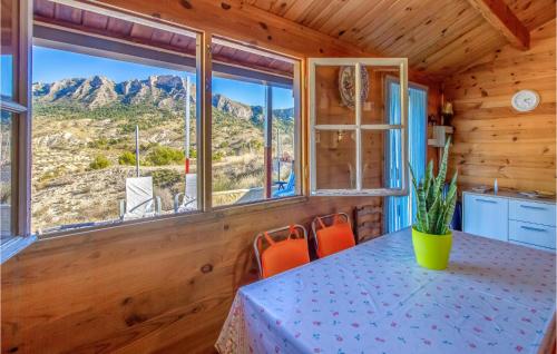 a dining room with a table and views of the mountains at Cozy Home In El Rellano Murcia in Las Casicas