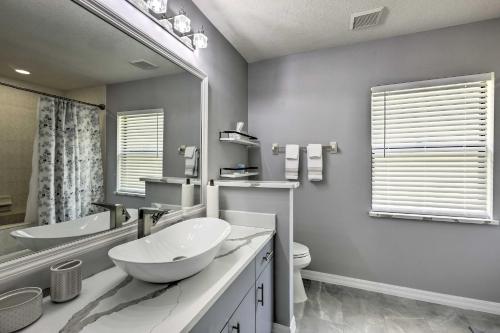 a bathroom with two sinks and a large mirror at 7 Mi to World Equestrian Center Ocala Casa Azul in Ocala