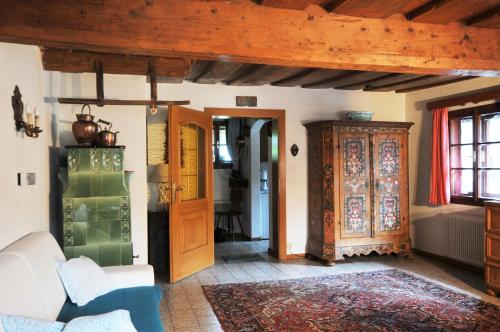 a living room with a couch and a wooden ceiling at Haus am Bach in Bad Kleinkirchheim