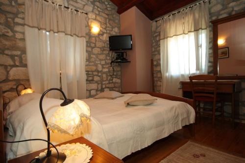a bedroom with a bed and a table with a lamp at Holiday house with a swimming pool Krsan - Vlasici, Central Istria - Sredisnja Istra - 7686 in Kršan