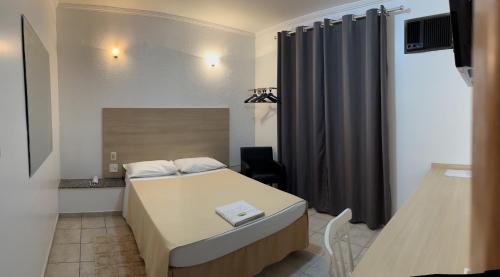 Postel nebo postele na pokoji v ubytování Hotel Taquaral