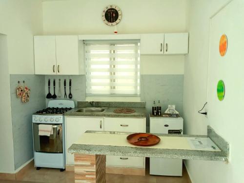 a kitchen with white cabinets and a plate on the counter at Dominican Dream Apartments in Punta Cana