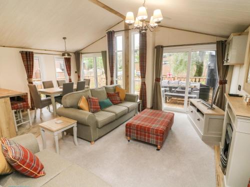 a living room with a couch and a table at Coniston View 9 in Carnforth