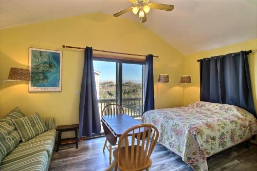 a living room with a bed and a couch at NC 12 56821-28 Condo in Hatteras
