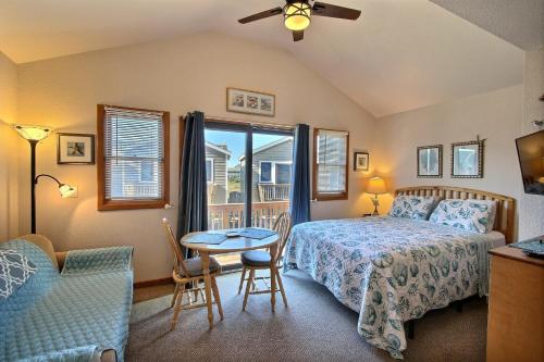 a bedroom with a bed and a table and a window at NC 12 56821-16 Condo in Hatteras