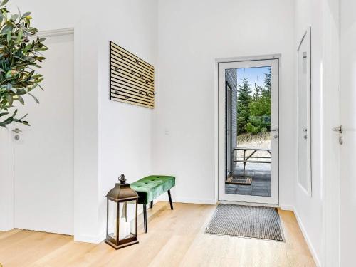 a white room with a green bench and a door at Modern Retreat in Graerup - By Traum Ferienwohnungen in Oksbøl
