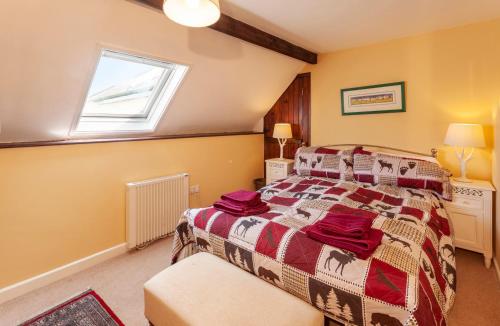 a bedroom with a bed and a window at Southcott Farm Cottage in Honiton