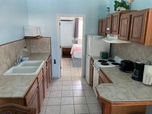 a kitchen with a sink and a stove top oven at Beautiful Villa just steps away from the beach! in Georgetown
