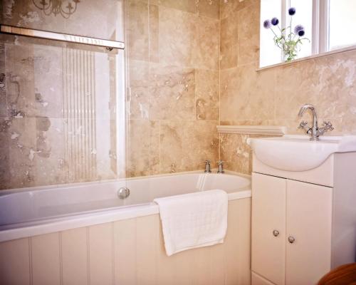博克斯的住宿－十字路口農場- 安妮女王馬厩酒店，带浴缸和盥洗盆的浴室
