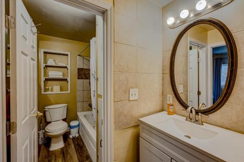 a bathroom with a toilet and a sink and a mirror at Pine Tree Place - Unit 7 in South Lake Tahoe