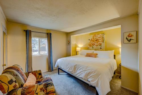 a bedroom with a white bed and a couch at Pine Tree Place - Unit 7 in South Lake Tahoe