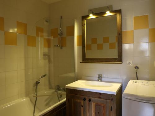 a bathroom with a sink and a tub and a mirror at Appartement Aussois, 3 pièces, 6 personnes - FR-1-508-276 in Aussois