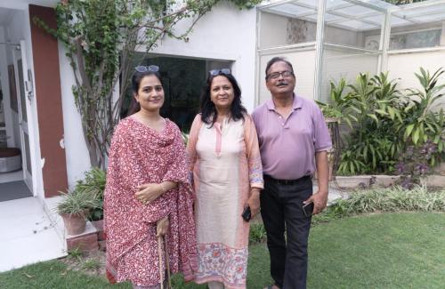a man and two women standing in front of a house at Green Serene Abode in Meerut