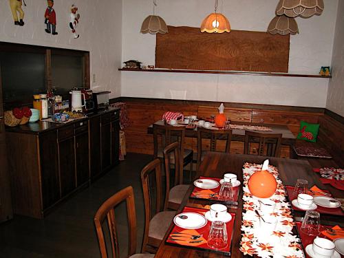 a dining room with tables and chairs in a restaurant at B&B Koyuki Hakuba in Hakuba