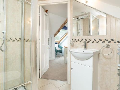 a bathroom with a sink and a shower at Larboard in Fowey