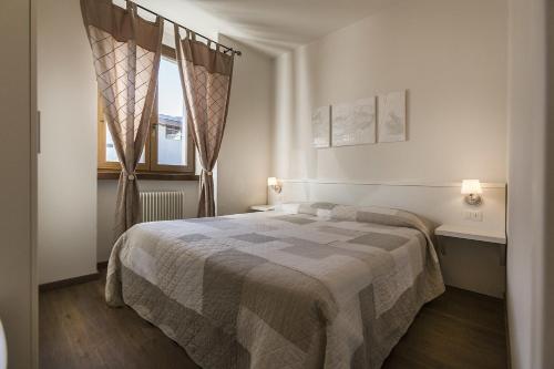 Postel nebo postele na pokoji v ubytování Le Servite Apartments