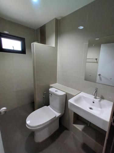 a bathroom with a white toilet and a sink at Buathong Pool Villa in Ban Khung Taphao