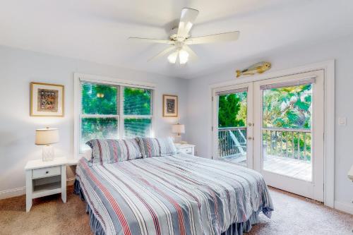 a bedroom with a bed and a ceiling fan at La Fiesta in St. George Island