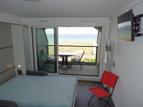une chambre avec un lit et un balcon avec une table et des chaises dans l'établissement Studio aux Sables-d'Olonne: Plage et commerces à proximité - FR-1-92-902, à Les Sables-dʼOlonne