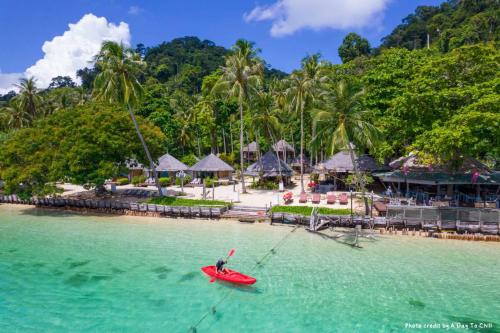 奈島的住宿－Thapwarin Resort - Green Hotel，渡假村旁边的水中一艘红船