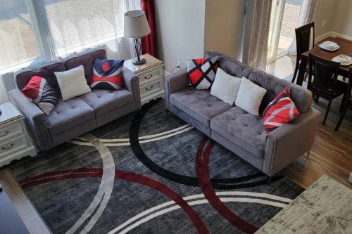 a living room with two couches and a rug at 3 bed 2.5 bath smart home with rv parking in Casper