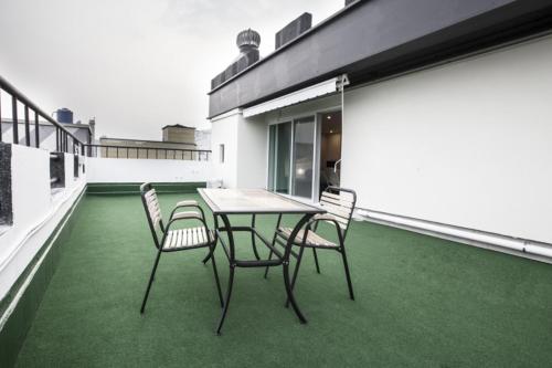 a patio with a table and chairs on a balcony at Number 25 Hotel Gimhae Eobang in Gimhae