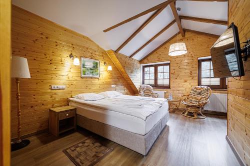a bedroom with a bed in a wooden wall at Leśne Patio in Katowice