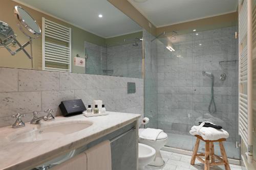 a bathroom with a sink and a toilet and a shower at Maison Borella in Milan