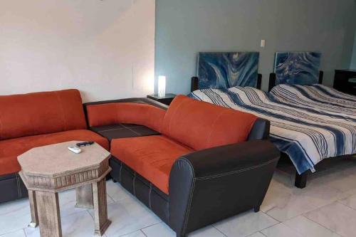 a living room with a couch and a bed at Cancun Oceanfront, Entire Apartment in Cancún