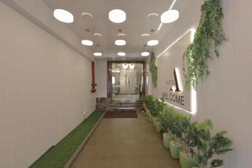 a corridor with potted plants in a hallway at Hotel Ariana Residency in Mumbai