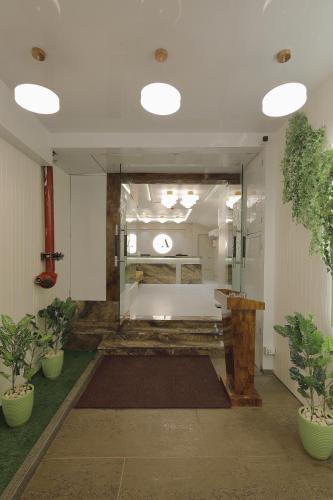 a large hallway with plants in a building at Hotel Ariana Residency in Mumbai