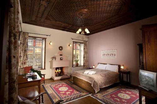 a bedroom with a bed and a fireplace at Porfyron in Ano Pedina