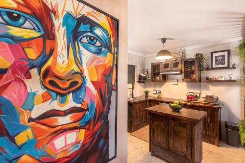 a kitchen with a large painting on the door of a room at TnT on Main in Hermanus