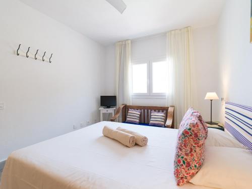 a bedroom with a bed with two rolled towels on it at Granada II Apartments in Puerto Rico de Gran Canaria