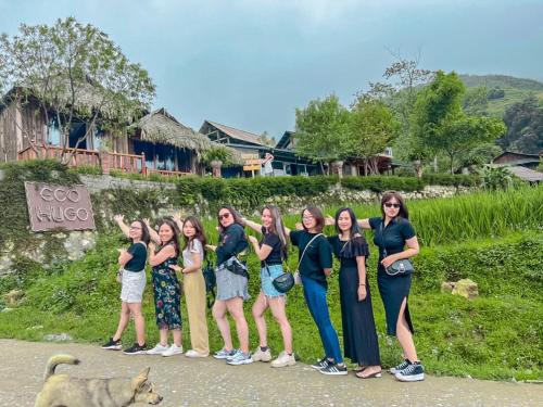 a group of girls posing for a picture with a dog at Sapa Eco Hugo in Sa Pa