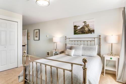 a bedroom with a metal bed with two lamps at The Ocean Is Calling in Westport