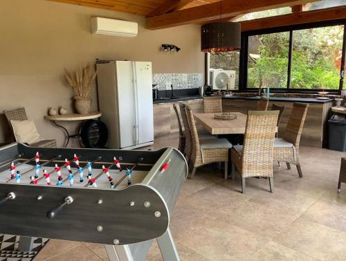 a living room with a pool table and a kitchen at Le Hameau des vanades in Ampus