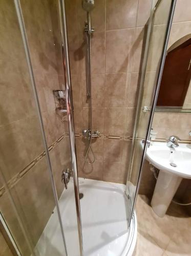 a shower with a glass door next to a sink at MitProt Panorama Bay 2 ap 31 in Sveti Vlas