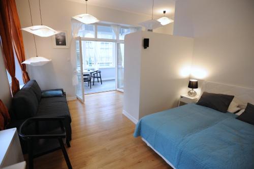 sypialnia z łóżkiem, kanapą i stołem w obiekcie Sopot Special Apartments w mieście Sopot