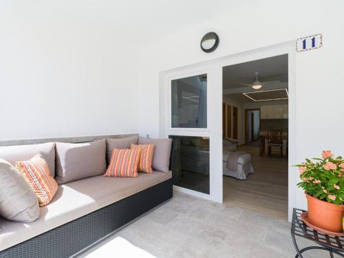 a living room with a couch and a sliding glass door at Granada II Apartments in Puerto Rico de Gran Canaria