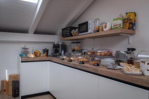 a kitchen with a counter with bread and food on it at La Casa Di Filò Boutique in Roseto degli Abruzzi