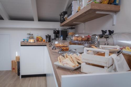 a kitchen with a counter with bread and other foods at La Casa Di Filò Boutique in Roseto degli Abruzzi