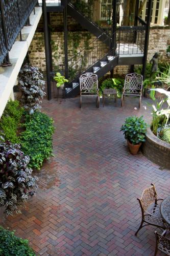 a patio with chairs and tables and a staircase at Eliza Thompson House, Historic Inns of Savannah Collection in Savannah