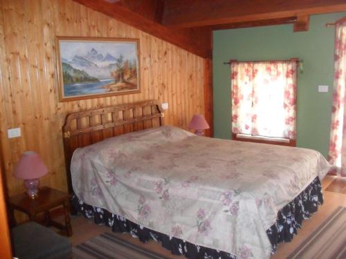 a bedroom with a bed in a room with wooden walls at Giamia Villas in Sulmona