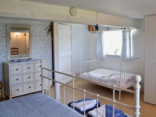 a bedroom with two bunk beds and a mirror at Southview Cottage in Newbridge