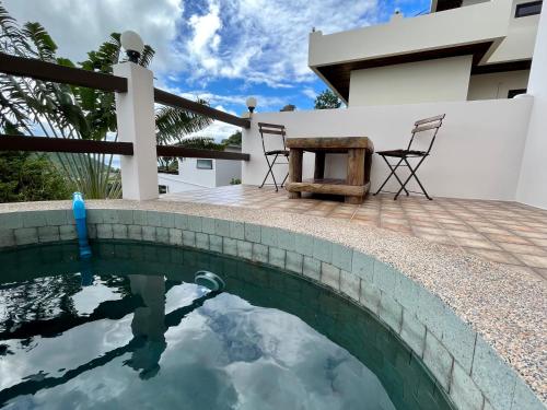 a swimming pool in front of a house at KohTao Studios Sunset in Koh Tao