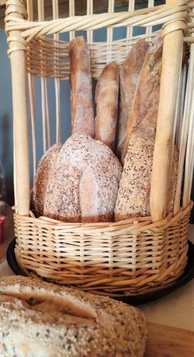 a basket filled with lots of different types of bread at Chalet Hôtel Les Blancs in Pra-Loup
